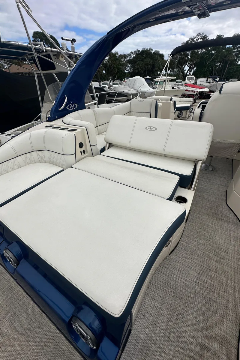 Slide: The Image of 2022 Harris Crowne SL 250 luxury boat with spacious white seating and sleek design. - 10