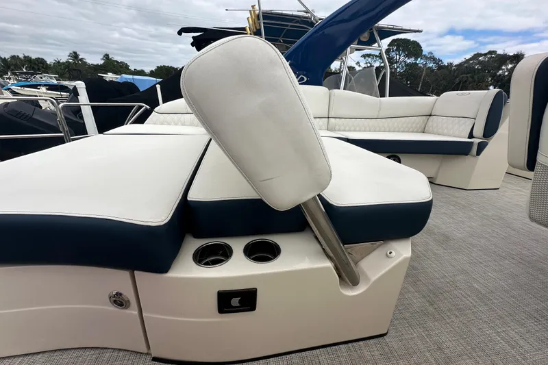 Slide: The Image of 2022 Harris Crowne SL 250 boat interior with white and blue seating. - 11