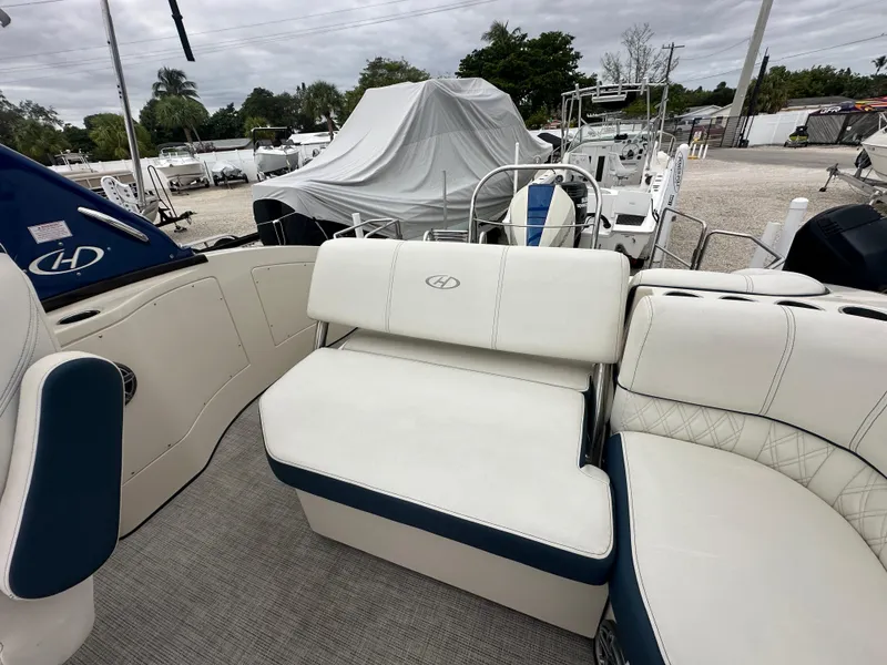 Slide: The Image of 2022 Harris Crowne SL 250 boat interior with white and blue seating. - 12