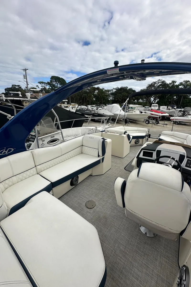 Slide: The Image of 2022 Harris Crowne SL 250 boat with luxurious seating and modern design. - 14
