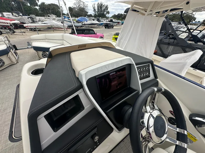 Slide: The Image of 2022 Harris Crowne SL 250 boat dashboard with steering wheel and control panel. - 21