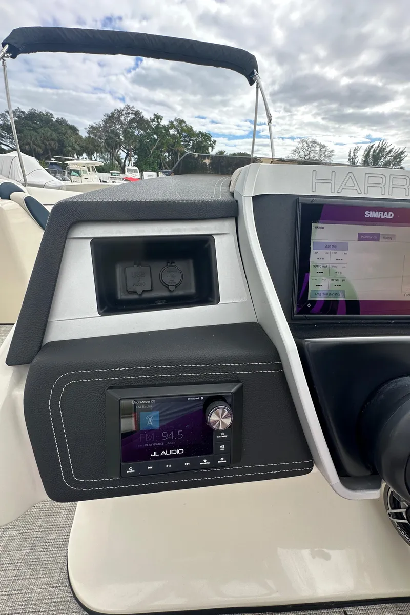 Slide: The Image of 2022 Harris Crowne SL 250 dashboard with navigation and audio controls. - 24