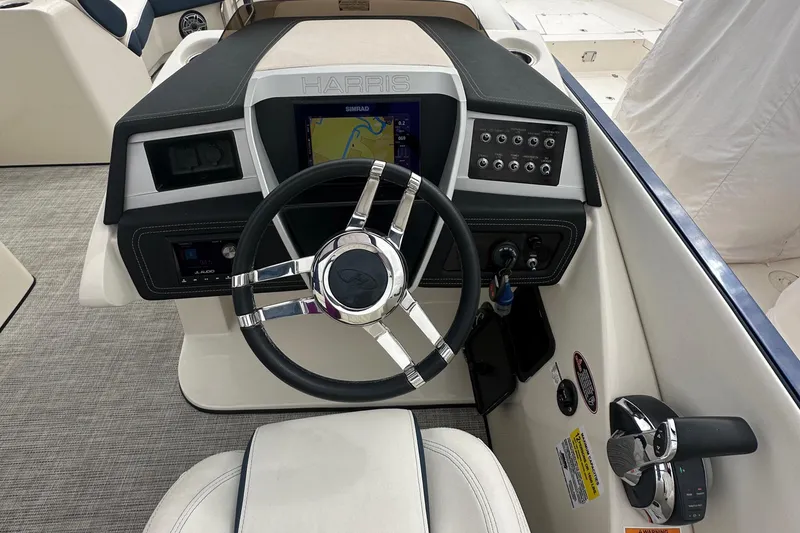 Slide: The Image of 2022 Harris Crowne SL 250 dashboard with steering wheel and navigation display. - 27