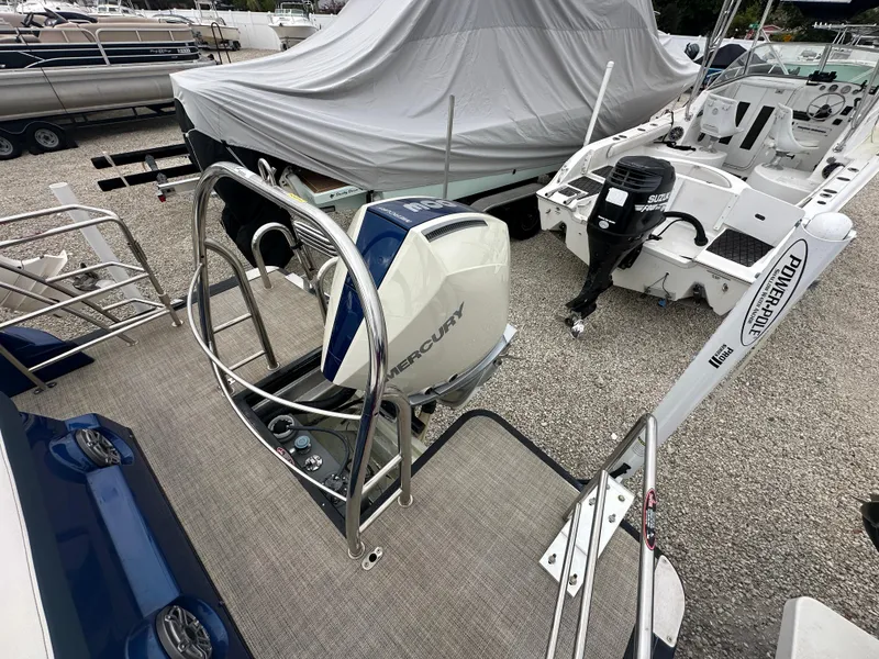 Slide: The Image of 2022 Harris Crowne SL 250 boat with Mercury outboard motor in a marina. - 3