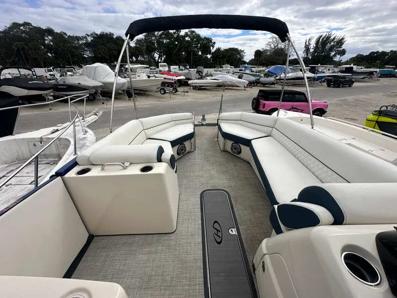 Slide: The Image of 2022 Harris Crowne SL 250 pontoon boat with spacious seating and sleek design. - 31