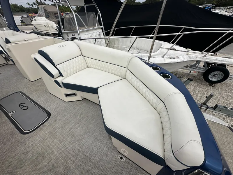 Slide: The Image of 2022 Harris Crowne SL 250 boat with luxurious white and blue seating. - 37