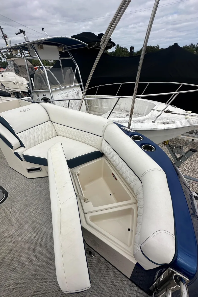 Slide: The Image of 2022 Harris Crowne SL 250 boat with luxurious seating and storage compartment. - 40