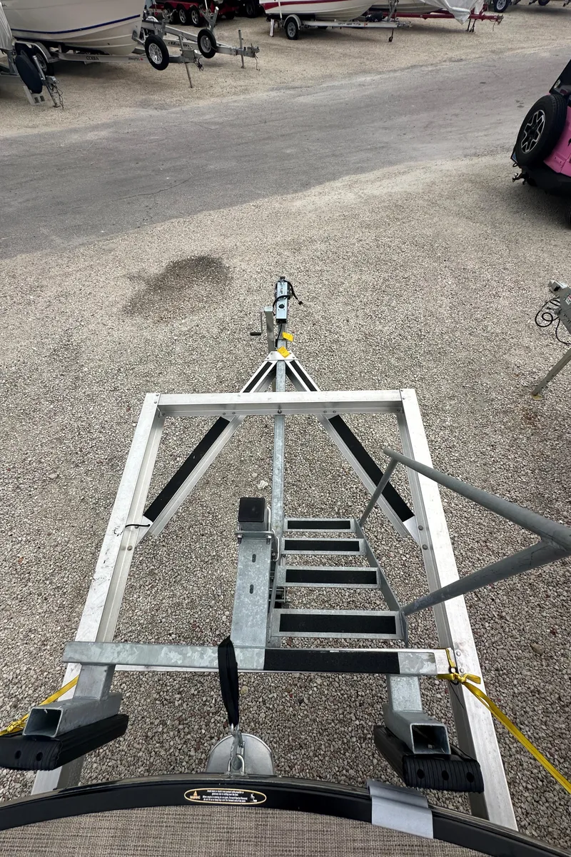 Slide: The Image of Trailer for 2022 Harris Crowne SL 250 boat in a parking area. - 44