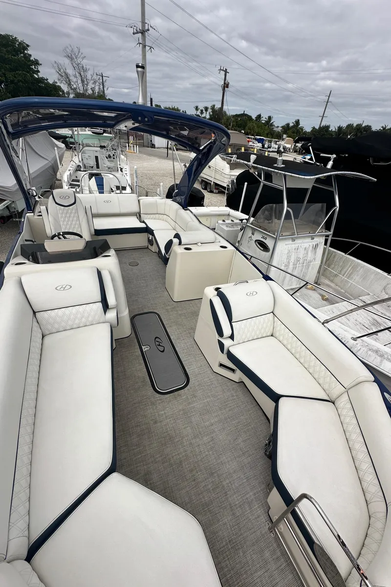 Slide: The Image of 2022 Harris Crowne SL 250 boat with spacious seating and modern design. - 47