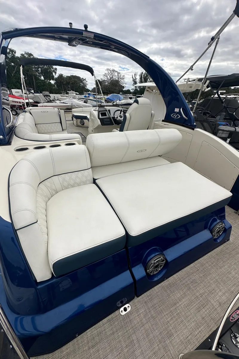 Slide: The Image of 2022 Harris Crowne SL 250 boat with luxurious seating and sleek design. - 5