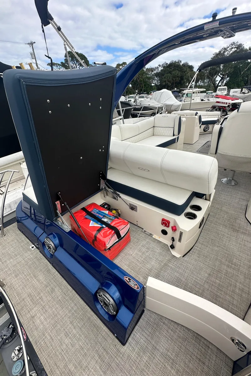 Slide: The Image of 2022 Harris Crowne SL 250 boat interior with seating and storage compartment. - 6
