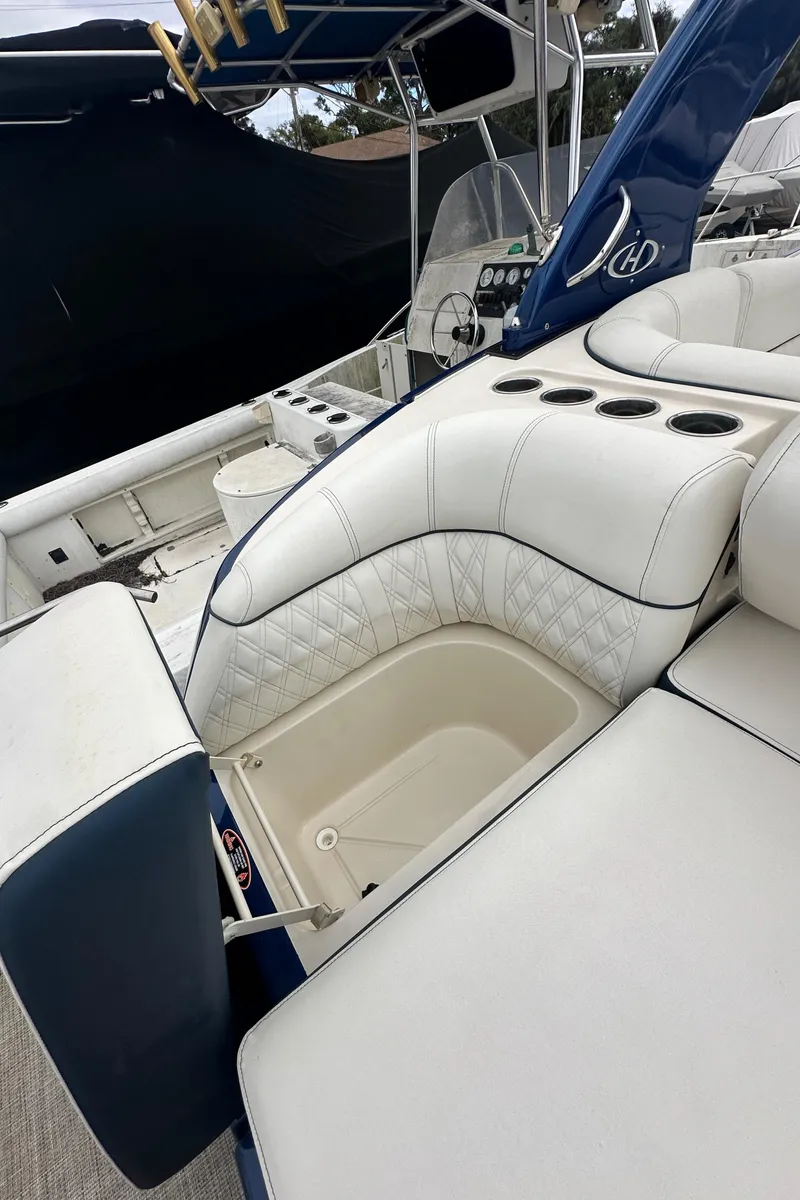 Slide: The Image of 2022 Harris Crowne SL 250 boat with luxurious white seating and cup holders. - 7