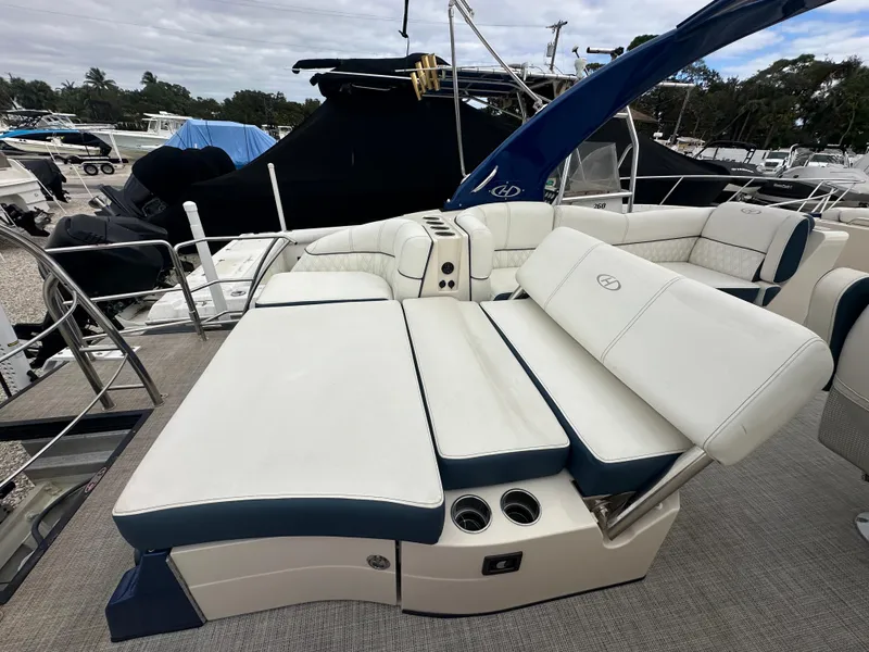 Slide: The Image of 2022 Harris Crowne SL 250 boat with luxurious white seating and blue accents. - 9