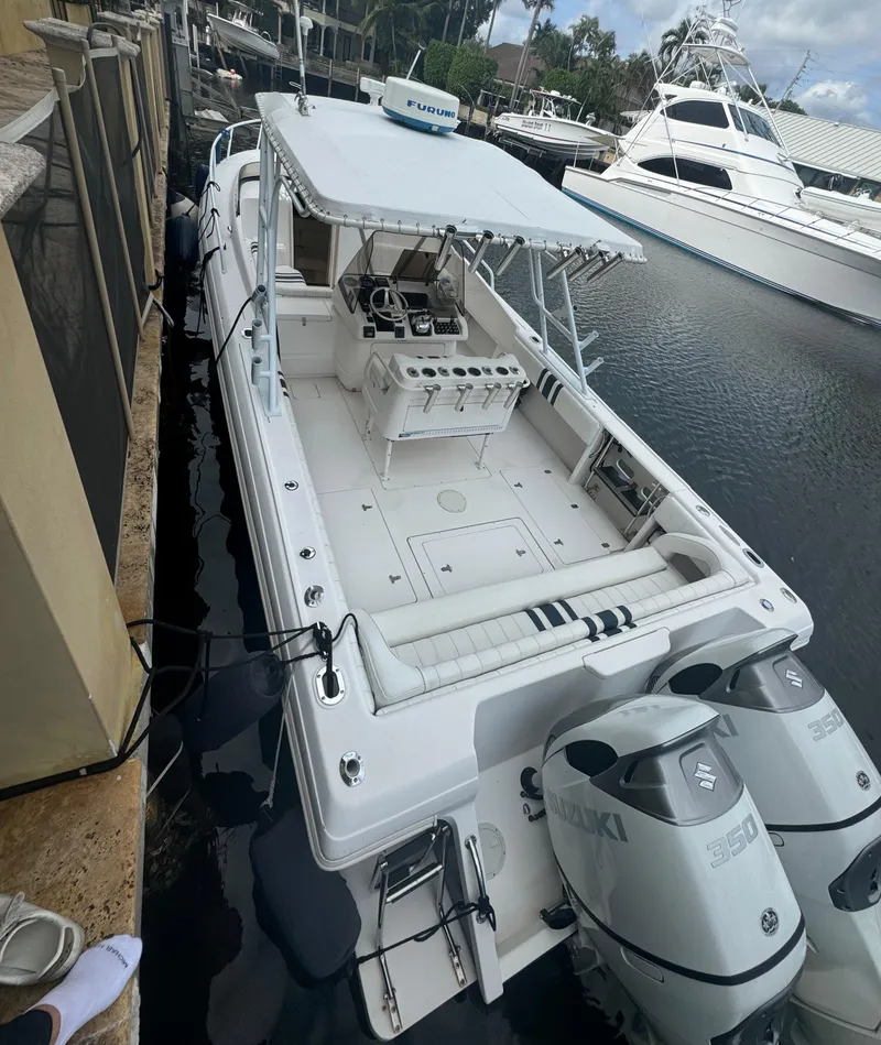 Slide: The Image of 2000 Intrepid 366 boat docked, featuring dual Suzuki engines and spacious deck layout. - 1