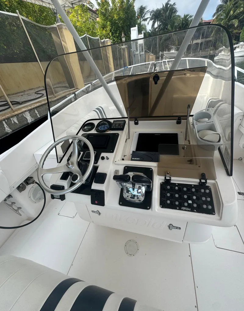 Slide: The Image of 2000 Intrepid 366 boat cockpit with steering wheel and control panel. - 12