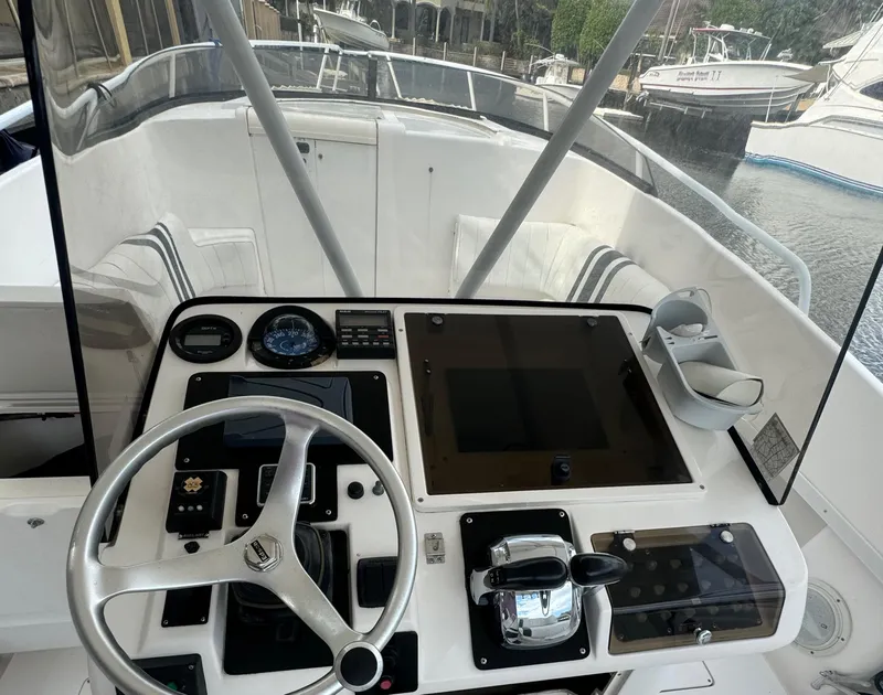 Slide: The Image of Cockpit of a 2000 Intrepid 366 boat with steering wheel and control panel. - 14