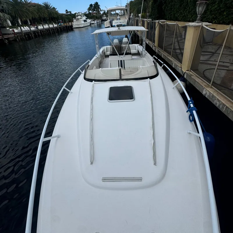 Slide: The Image of 2000 Intrepid 366 boat docked in a serene marina setting. - 22