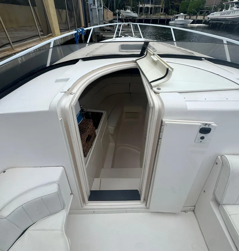 Slide: The Image of 2000 Intrepid 366 boat interior with open cabin door, docked at marina. - 25