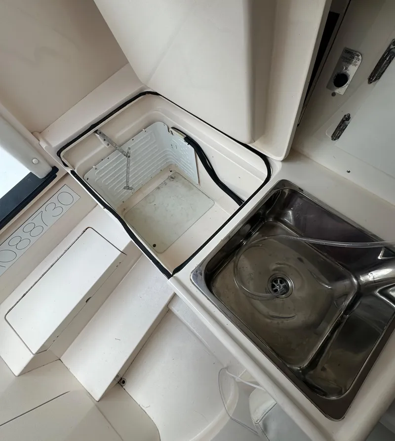 Slide: The Image of 2000 Intrepid 366 boat interior with sink and storage compartments. - 28