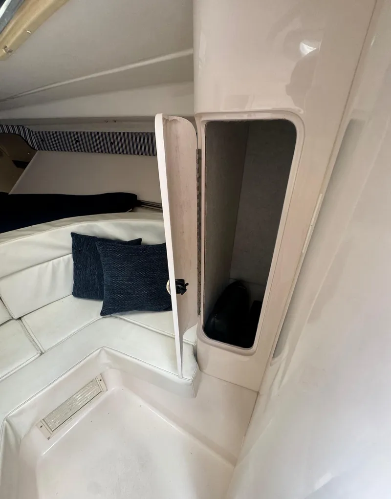 Slide: The Image of Interior of a 2000 Intrepid 366 boat with open storage compartment and cushions. - 29