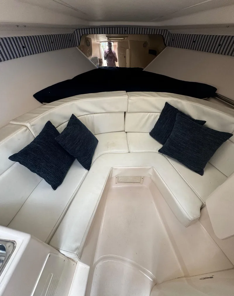 Slide: The Image of Interior of a 2000 Intrepid 366 boat with white seating and dark cushions. - 31
