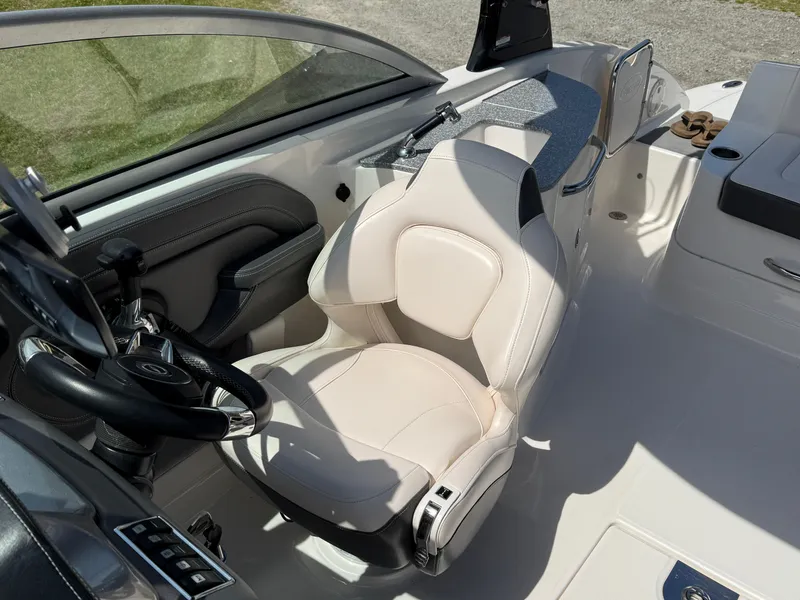 Slide: The Image of 2016 Chaparral 244 boat interior with steering wheel and white captain's seat. - 10
