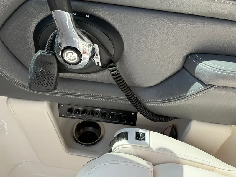 Slide: The Image of 2016 Chaparral 244 boat control panel with throttle and audio controls. - 12