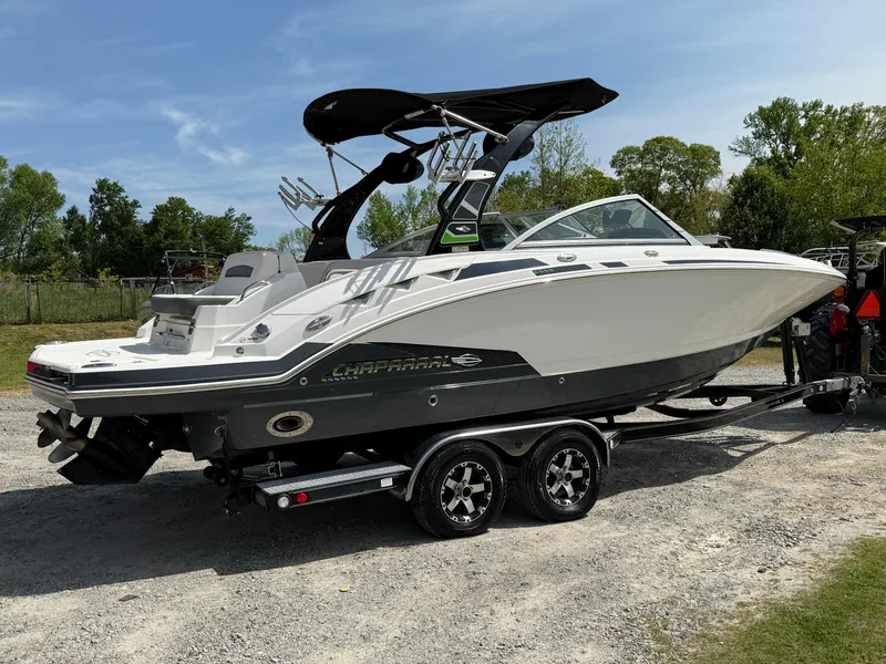 Slide: The Image of 2016 Chaparral 244 boat on trailer, parked outdoors under clear sky. - 5