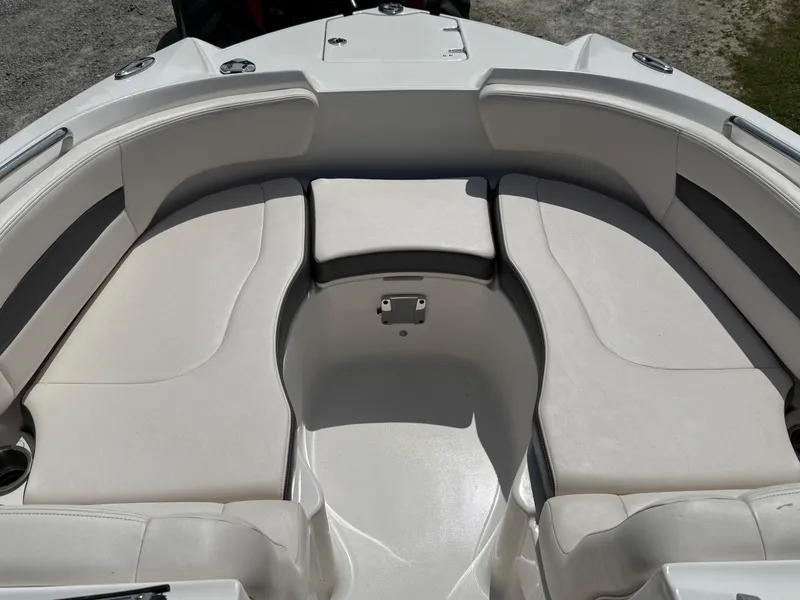 Slide: The Image of 2016 Chaparral 244 boat interior with white cushioned seating. - 6