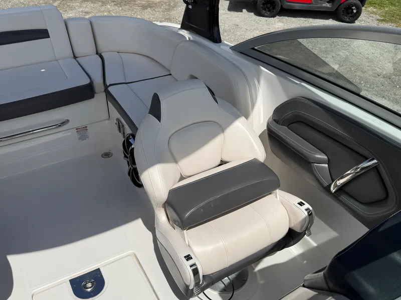 Slide: The Image of 2016 Chaparral 244 boat interior with white and gray seating. - 9