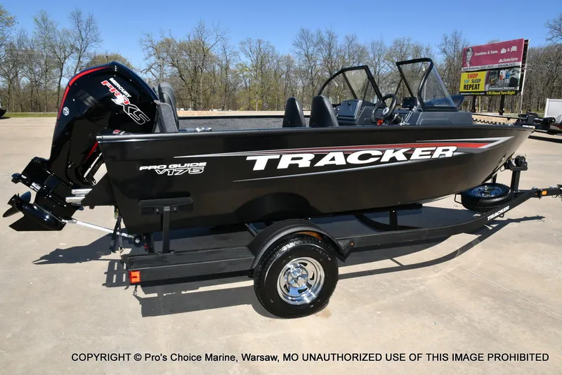 Slide: The Image of 2025 Tracker Pro Guide V-175 Combo boat on trailer, outdoors, side view. - 14