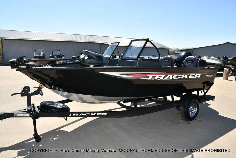 Slide: The Image of 2025 Tracker Pro Guide V-175 Combo boat on trailer, parked outdoors. - 21
