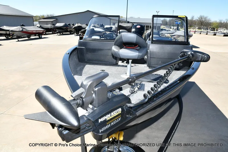 Slide: The Image of 2025 Tracker Pro Guide V-175 Combo boat with Minn Kota trolling motor in a showroom. - 25