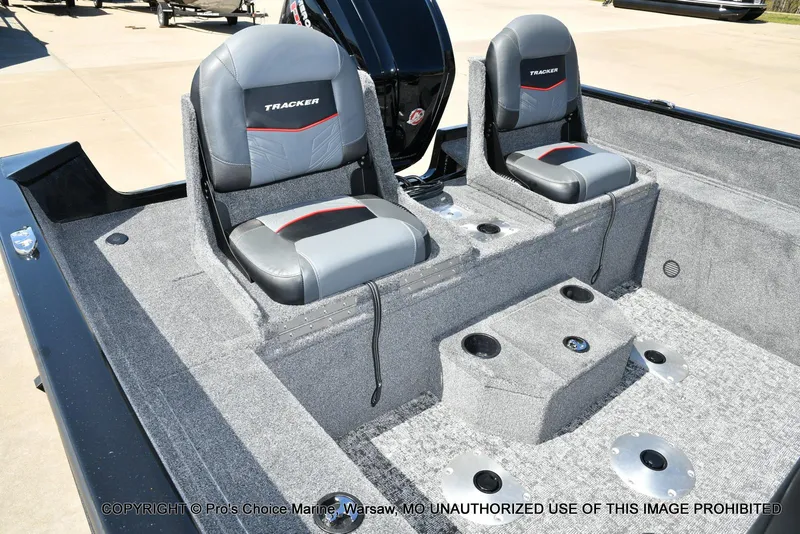 Slide: The Image of 2025 Tracker Pro Guide V-175 Combo boat interior with two gray seats and carpeted flooring. - 3