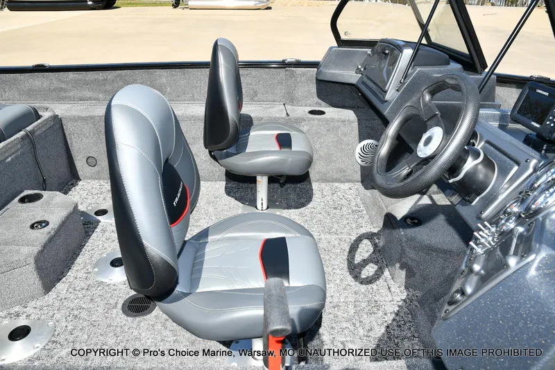 Slide: The Image of 2025 Tracker Pro Guide V-175 Combo boat interior with gray seating and steering console. - 30