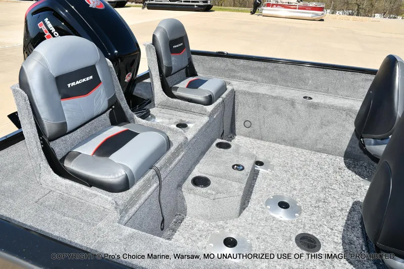 Slide: The Image of 2025 Tracker Pro Guide V-175 Combo boat interior with gray seating and carpeted flooring. - 32