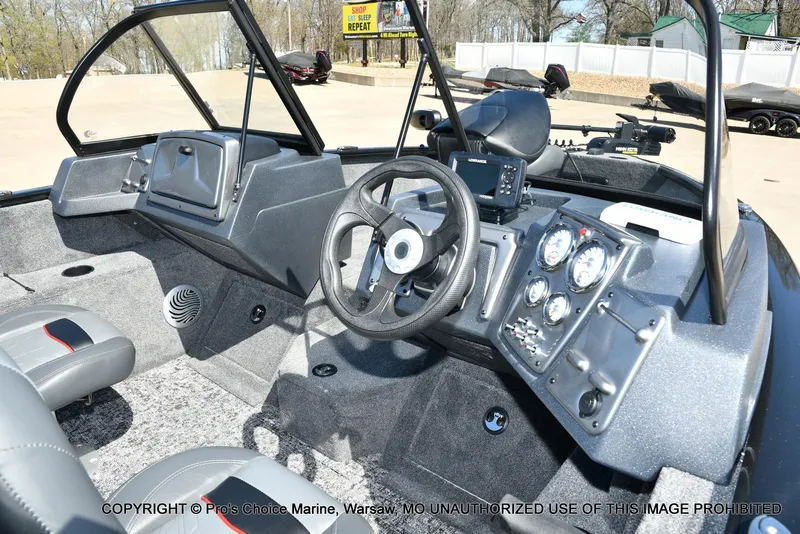 Slide: The Image of 2025 Tracker Pro Guide V-175 Combo boat interior with steering wheel and control panel. - 4