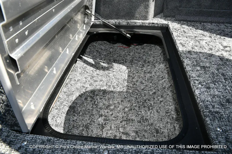 Slide: The Image of Storage compartment in 2025 Tracker Pro Guide V-175 Combo boat, featuring carpeted interior. - 45