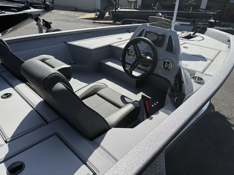Slide: The Image of 2025 Xpress Hyper-Lift Bass Series boat interior with steering wheel and seating. - 3
