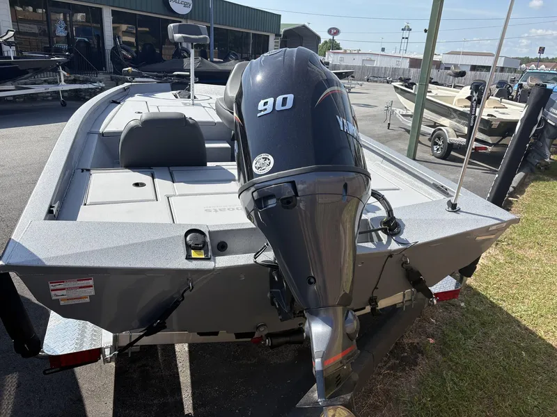 Slide: The Image of 2025 Xpress Hyper-Lift Bass Series boat with Yamaha 90 engine, parked outdoors. - 5