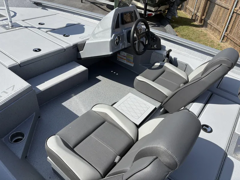 Slide: The Image of 2025 Xpress Hyper-Lift Bass Series boat interior with dual seats and steering console. - 6