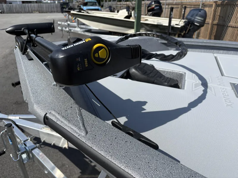 Slide: The Image of 2025 Xpress Hyper-Lift Bass Series boat with Minn Kota trolling motor on deck. - 7