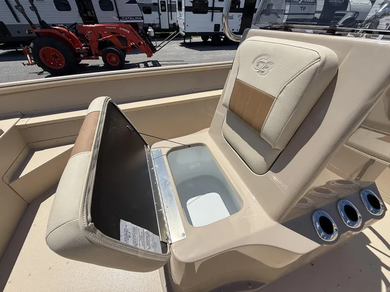 Slide: The Image of 2025 G3 Bay 20 boat seat with storage compartment, beige upholstery, and cup holders. - 3