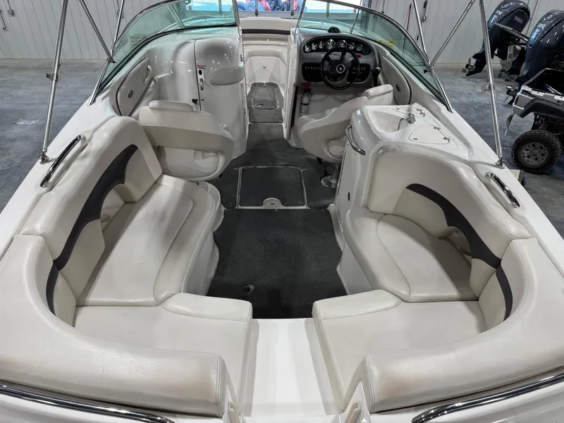 Slide: The Image of 2004 Chaparral 260 SSi boat interior with white seating and steering console. - 10