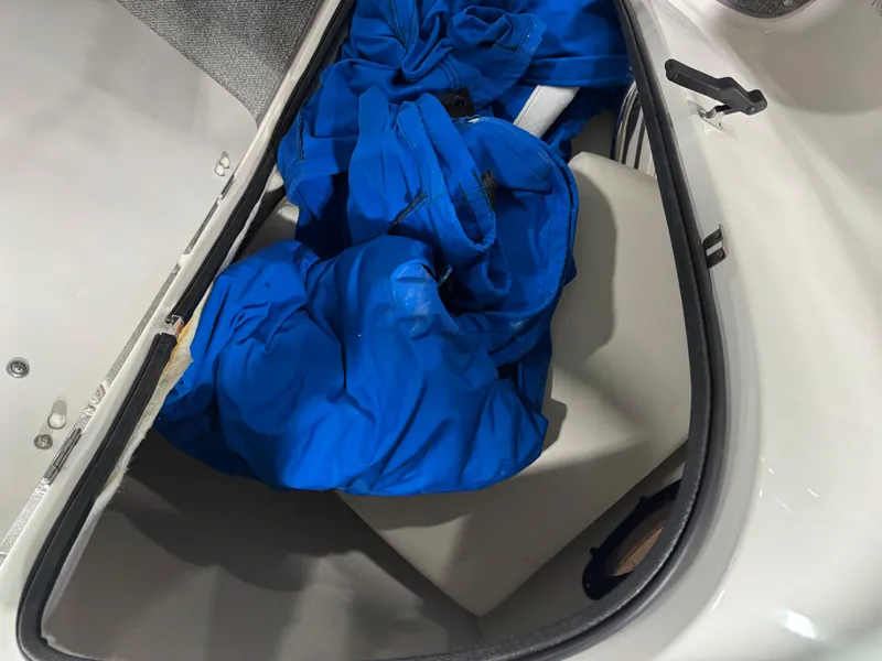 Slide: The Image of Storage compartment of 2004 Chaparral 260 SSi boat with blue cover inside. - 13