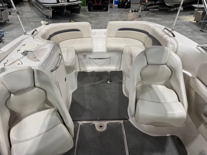 Slide: The Image of 2004 Chaparral 260 SSi boat interior with white seating and gray carpet. - 6