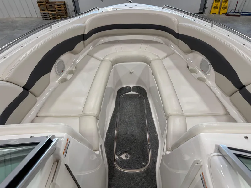 Slide: The Image of 2004 Chaparral 260 SSi boat interior with white seating and gray carpet. - 7