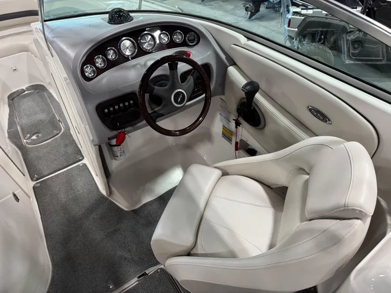Slide: The Image of 2004 Chaparral 260 SSi boat interior with steering wheel and dashboard controls. - 9