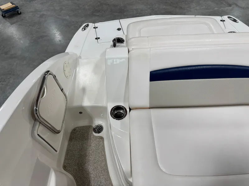 Slide: The Image of 2010 Chaparral 264 Sunesta boat interior with white seating and cup holders. - 10