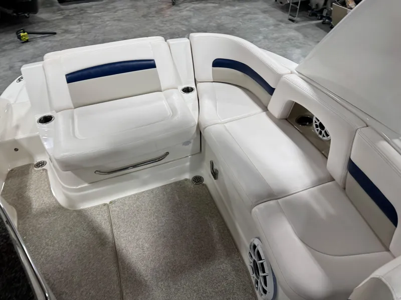Slide: The Image of 2010 Chaparral 264 Sunesta boat interior with white seating and blue accents. - 11